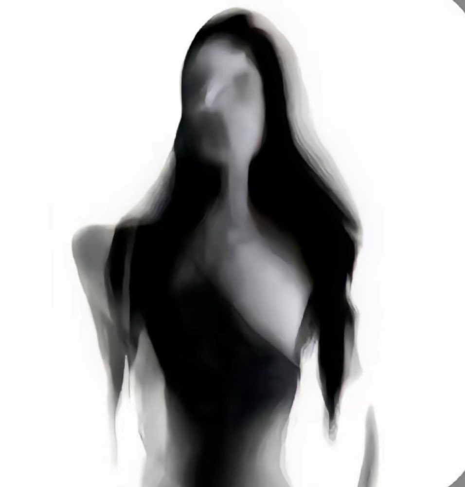 A blurred figure with long dark hair against white